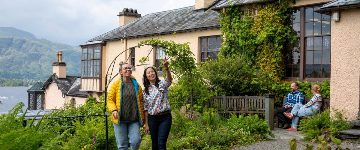 Visitors exploring the gardens outside of Brantwood, home of John Ruskin