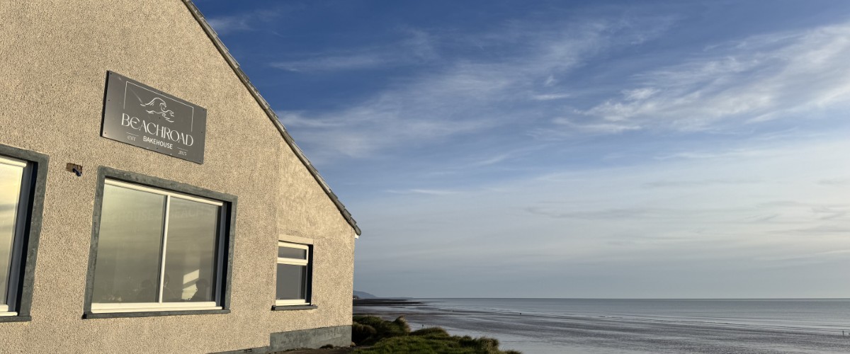 Exterior of Beach Road Bakehouse and St Bees beach at sunset