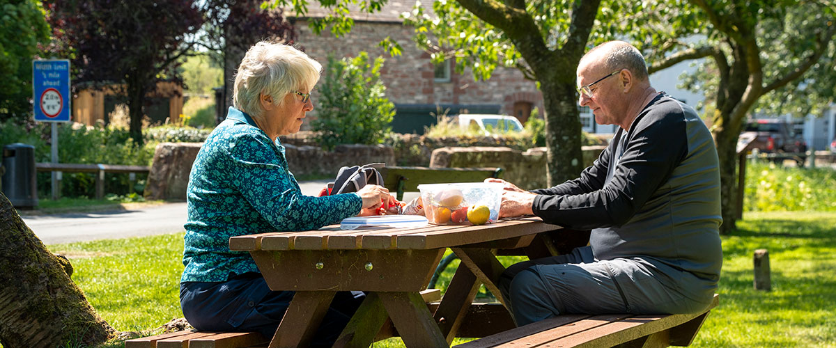 People enjoying a picnic lunch whilst walking the Westmorland and Furness Way